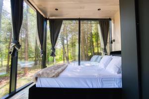 a bedroom with a bed in front of a window at The Haüs Windham - Spacious Suites, Hot Tub, Mountain Views! in Windham
