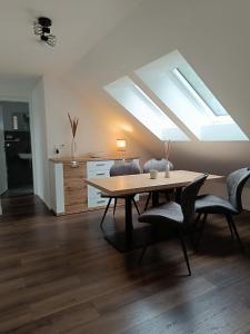 a dining room with a table and a skylight at Moderne Ferienwohnung für Familien im Dachgeschoss in Bosau
