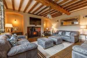 a living room with couches and a fireplace at Catton Old Hall Norwich in Norwich