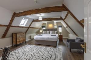 a bedroom with a bed and a chair in a attic at Catton Old Hall Norwich in Norwich +51 photos