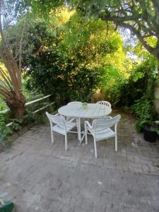 a white table and two chairs on a patio at Kamertje in Asse
