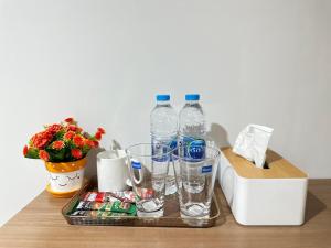 two bottles of water sitting on top of a table at Pingchan Hotel Soidao in Ban Phra Trong