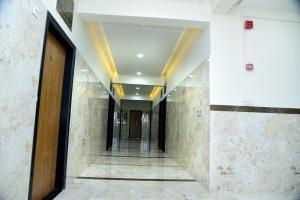 a hallway of a building with a door and stairs at Jainsite Bhavan in Pālitāna