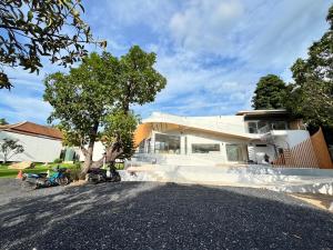 a house with a motorcycle parked in front of it at Celine House by Craft Village in Chaweng