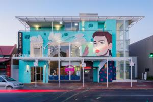 Un bâtiment bleu avec une peinture d'une femme. dans l'établissement Majestic Minima Hotel, à Adélaïde