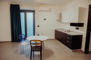 a kitchen with a table and two chairs and a table at VicoLetto Bed and Breakfast in Laino Borgo