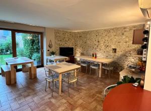 a room with tables and chairs and a tv at Alc&cE' alloggio agrituristico in Povoletto