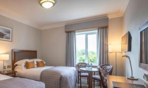 Ένα ή περισσότερα κρεβάτια σε δωμάτιο στο Temple Gate Hotel