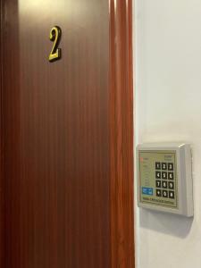 a door with a number two on it and a clock at Sufara Hotel Suites in Amman
