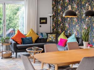 a living room with a couch with colorful pillows at Boutique Family Stay in the Heart of Surrey - Pass the Keys in Leatherhead