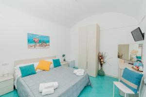 a bedroom with a bed with colorful pillows at Albergo Diffuso Bacco Furore in Furore