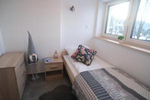 une petite chambre avec un lit et une fenêtre dans l'établissement Pokój jednoosobowy, à Zakopane