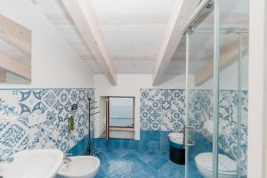a bathroom with two sinks and a shower at Albergo Diffuso Bacco Furore in Furore