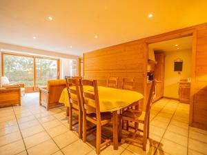 a dining room with a yellow table and chairs at Appartement 3 chambres avec terrasse, centre village, piste et commerces à pied, garage et WIFI - FR-1-437-104 in La Clusaz