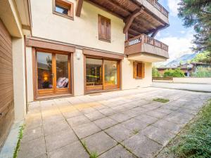 a house with a balcony and a patio at Appartement 3 chambres avec terrasse, centre village, piste et commerces à pied, garage et WIFI - FR-1-437-104 in La Clusaz +4 photos