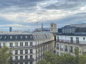 a view of a city with buildings and a crane at Studio Victoria - Centre de Paris in Paris