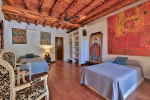 a bedroom with two beds and a wooden ceiling at Villa Kumharas in Santa Agnès de Corona +36 photos