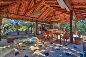 a large outdoor patio with a table and chairs at Villa Kumharas in Santa Agnès de Corona