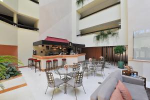 a restaurant with tables and chairs and a bar at Amazing Sea View in Cascais