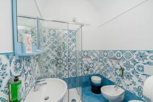 a bathroom with a shower and a sink and a toilet at Albergo Diffuso Bacco Furore in Furore
