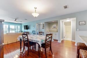 a dining room and kitchen with a table and chairs at Mariners Cay 40 in Folly Beach +28 photos
