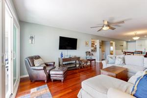 a living room with a couch and a tv at Mariners Cay 40 in Folly Beach