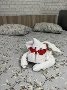 a stuffed animal is laying on a bed at Casa Elena in Constanţa