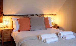 a bedroom with a bed with towels on it at Glasswing Stays The Nest in Whitby