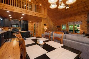 a dining room and kitchen in a log cabin at Blue Line Vista - Private Cabin Ellijay GA - Hot Tub, Game Room, Fire Pit, Private Balcony, Outdoor Dining - Ellijay, GA in Ellijay