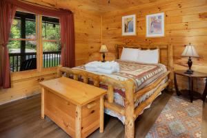 a bedroom with a bed in a log cabin at Blue Line Vista - Private Cabin Ellijay GA - Hot Tub, Game Room, Fire Pit, Private Balcony, Outdoor Dining - Ellijay, GA in Ellijay +55 photos