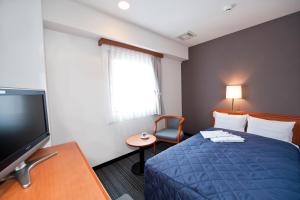 Postel nebo postele na pokoji v ubytování Hotel Unisite Sendai