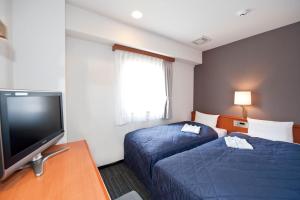Postel nebo postele na pokoji v ubytování Hotel Unisite Sendai