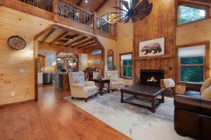 a living room with a fireplace and a dining room at Goose Island Retreat Luxurious Vacation Getaway in Cherry Log