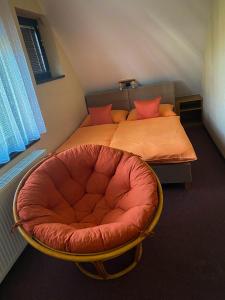a bedroom with a bed with a red chair at Penzion Z&Z in Tábor