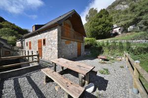 a wooden bench in front of a building at Bergerie route de Piau Engaly in Aragnouet +12 photos