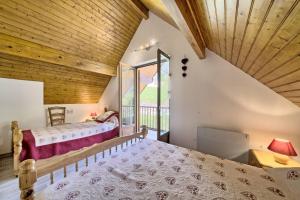 a bedroom with two beds and a large window at Bergerie route de Piau Engaly in Aragnouet