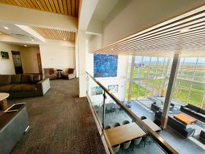 a living room with a couch and a large window at Blackbush Beach Resort in Covehead