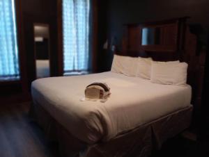 a hotel room with a bed with a hat on it at Grand Central Hotel in Eureka Springs