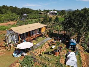 an overhead view of a farm with a building and tents at Mầm Farmstay And Camping in Lam Ha