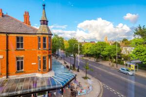a building with a tower on the side of a street at Elysée Suites - Spacious 1 Bed Flat in Southport in Southport