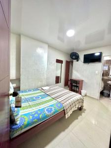 a bedroom with a bed and a flat screen tv at Vista azul in Bucaramanga +4 photos
