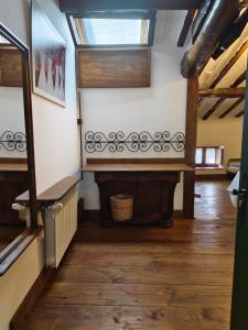 a hallway with a staircase with wooden floors and a window at Los Colmenares in Cuzcurrita-Río Tirón +72 photos