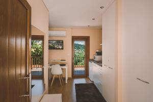a small kitchen with a table and a desk at Quinta do Lameiro in Tarouca