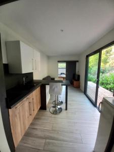 a kitchen with a table and a chair in a room at Tiny house dans l'ouest lyonnais in Sain-Bel