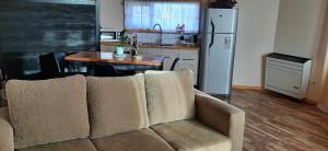 a living room with a couch and a kitchen at your-space in El Calafate