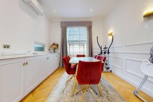 a kitchen with a table and red chairs at -Air Con- Premium House - Prime location in London
