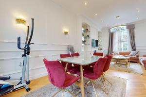 a dining room with a table and red chairs at -Air Con- Premium House - Prime location in London