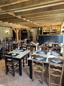 a restaurant with tables and chairs and a bar at La Ferme de Maraval in Cénac-et-Saint-Julien