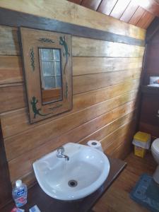 a bathroom with a sink and a mirror at Charming Yellow Houses studio with terrace in Bocas del Toro