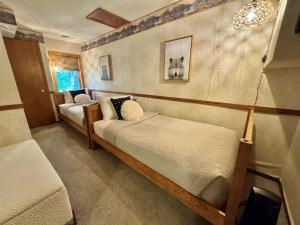 a bedroom with two beds in a room at Cozy Townhome at Lutsen Mtn - Ski-in, Ski-out, Pool, Hot Tub, Fitness Center, resort amenities galore! in Lutsen +47 photos